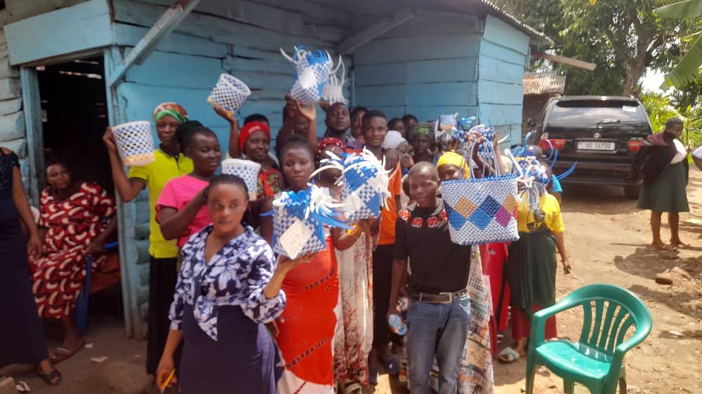 Women and youth showcasing handmade crafts during ROSAM skills training
