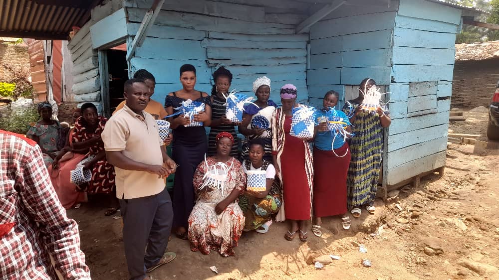 Pastor Baguma with women during hands-on skills empowerment training
